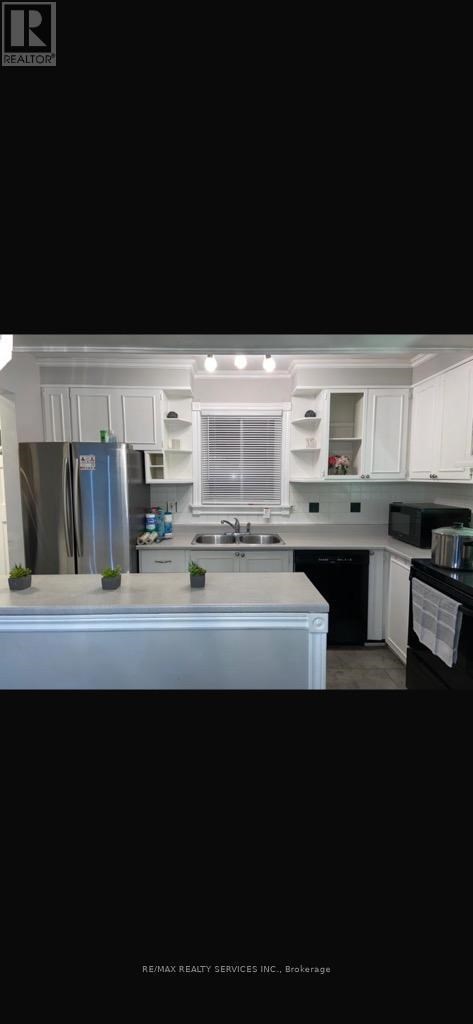A modern kitchen with white cabinets and a large island.