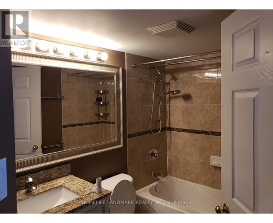 A bathroom with a sink, mirror, and bathtub.