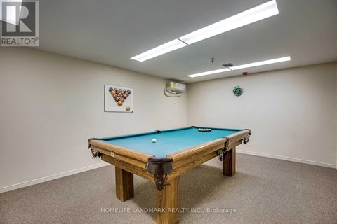 A pool table in a room with a light colored wall.