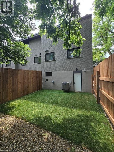 A backyard with a wooden fence and a small shed.