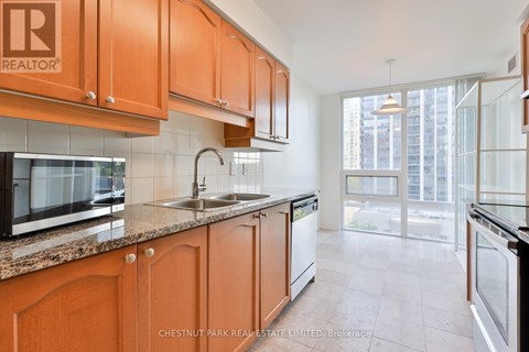 A kitchen with wooden cabinets and a sink.