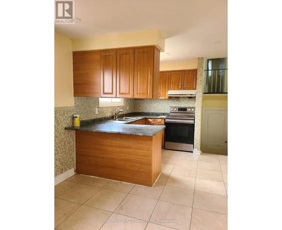A kitchen with wooden cabinets and a granite countertop.