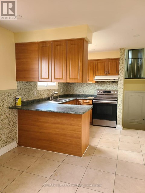 A kitchen with wooden cabinets and a granite countertop.