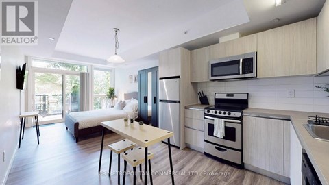 A modern kitchen with a dining table and chairs.