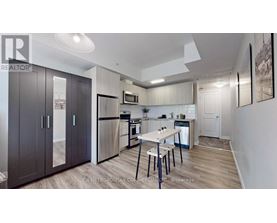 A well-lit kitchen with a dining table and chairs.