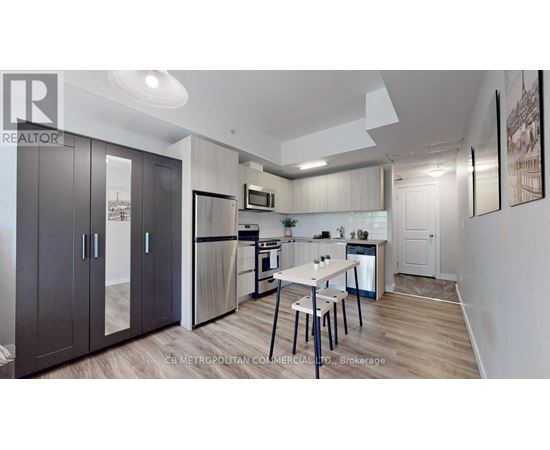 A well-lit kitchen with a dining table and chairs.