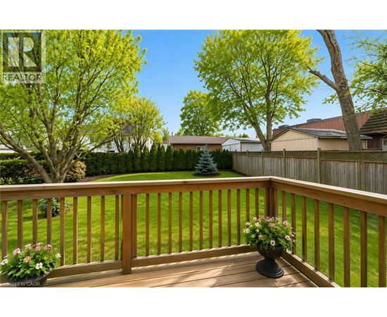 A wooden deck with a planter on it.