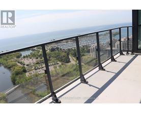 A balcony with a view of a river and buildings.