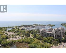 A bird's eye view of a city with a body of water and apartment buildings.
