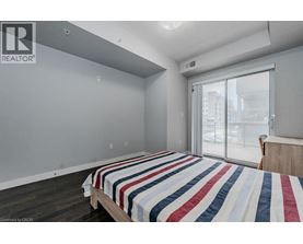 A bedroom with a bed and a window.