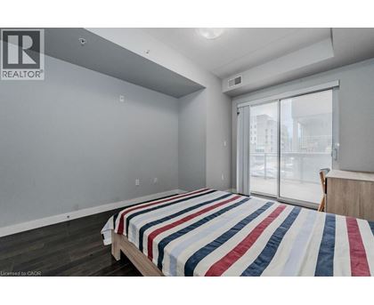 A bedroom with a bed and a window.