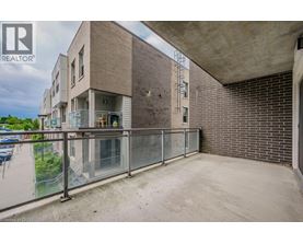A building with a balcony and a glass railing.
