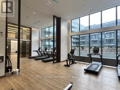 A gym with treadmills and exercise bikes is shown.