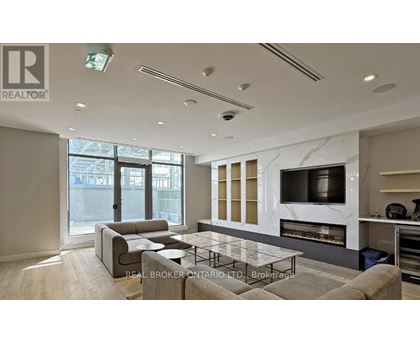 A modern living room with a grey sofa and a glass coffee table.