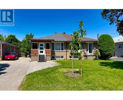 A house with a tree in front of it is for sale.