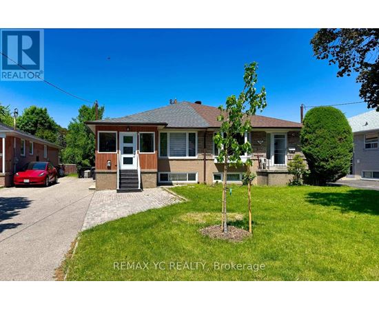 A house with a tree in front of it is for sale.