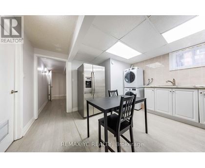 A kitchen area with a table and chairs.