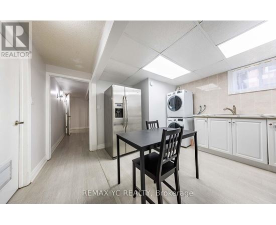 A kitchen area with a table and chairs.