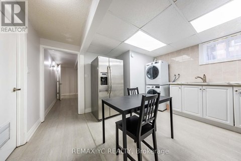 A kitchen area with a table and chairs.