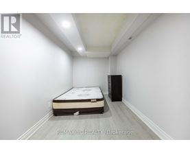 A bedroom with a bed and a cabinet in it.
