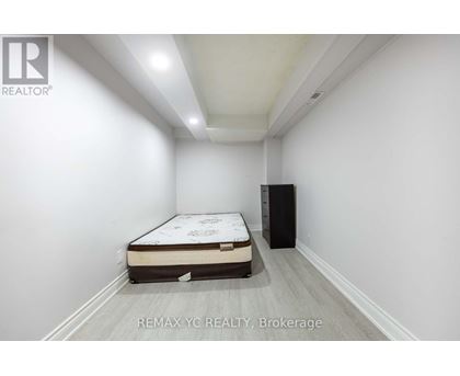 A bedroom with a bed and a cabinet in it.