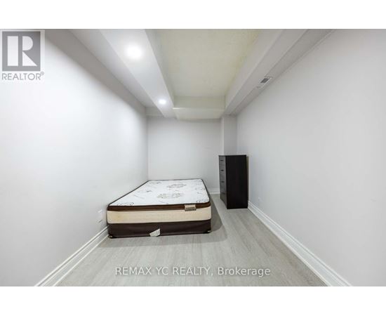 A bedroom with a bed and a cabinet in it.