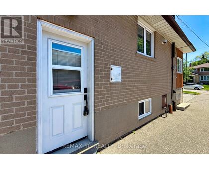 A house with a white door and a sign that says REMAX YC REALTOR Brokerage.