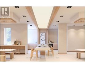 A modern dining room with a white table and chairs.