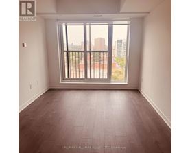 A room with a large window and a view of the city.