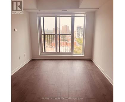 A room with a large window and a view of the city.