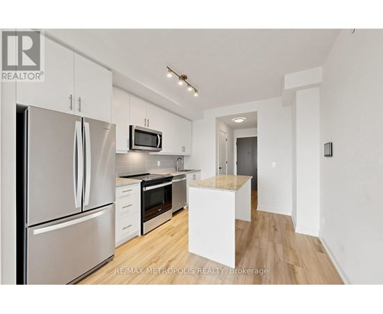 A kitchen with white cabinets and stainless steel appliances.