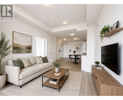 A living room with a couch, coffee table, and television.