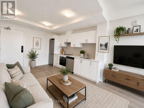 A living room with a white couch and a wooden coffee table.
