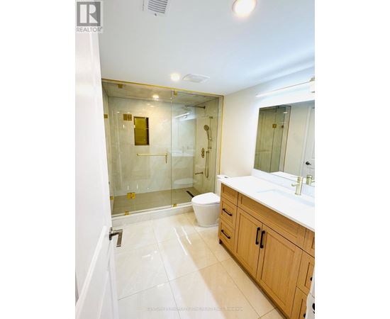 A bathroom with a toilet, sink, and shower.