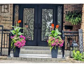 A black door with a glass window and a metal grill.