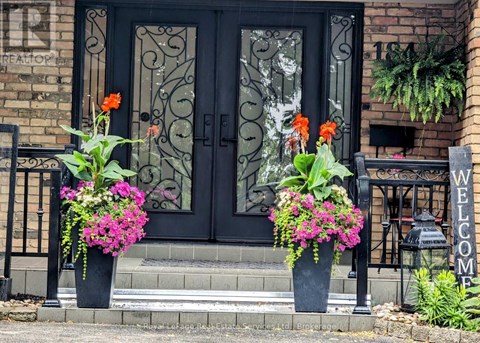 A black door with a glass window and a metal grill.
