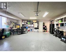 A spacious room with a green machine on the left and a white cabinet on the right.