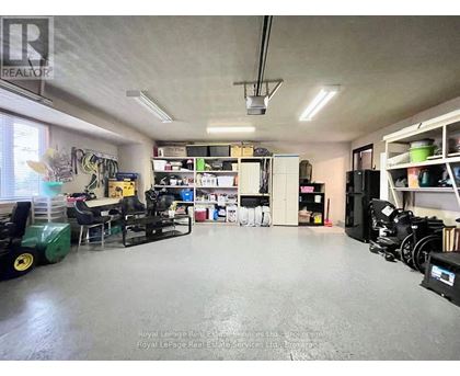 A spacious room with a green machine on the left and a white cabinet on the right.