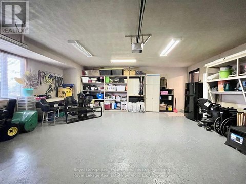 A spacious room with a green machine on the left and a white cabinet on the right.