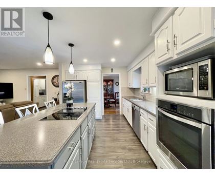 A modern kitchen with stainless steel appliances and a central island.