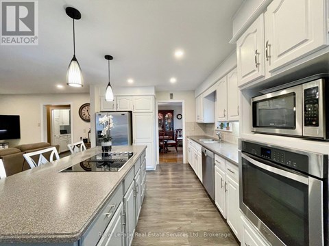 A modern kitchen with stainless steel appliances and a central island.
