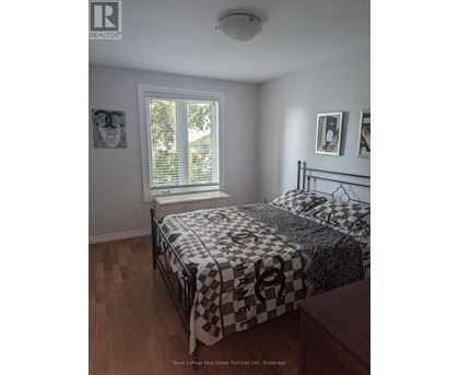 A bedroom with a bed and a window.