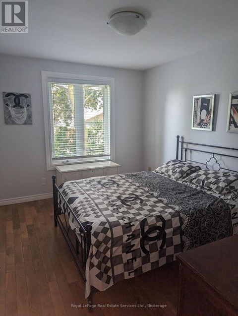 A bedroom with a bed and a window.