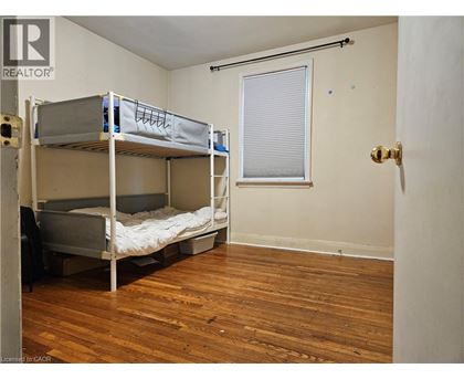 A bedroom with bunk beds and a window.