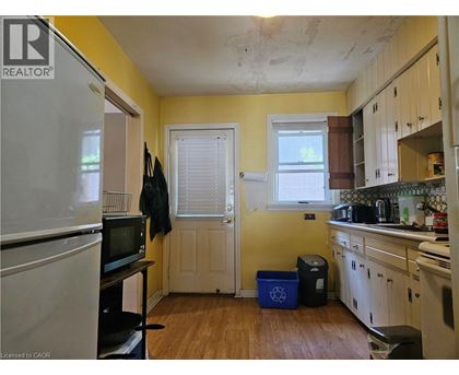 A kitchen with a white refrigerator and wooden cabinets.