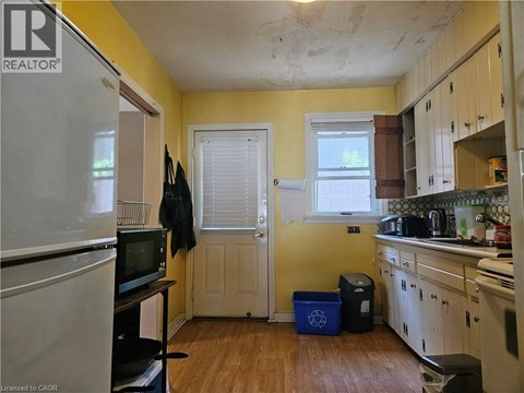A kitchen with a white refrigerator and wooden cabinets.