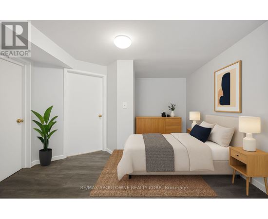 A bedroom with a bed, nightstand, and lamp.