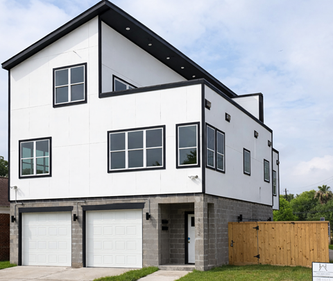 A modern two-story house with a white exterior and black accents.