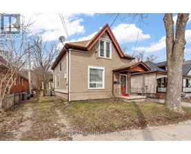 A house with a brown roof and a red door is for sale.