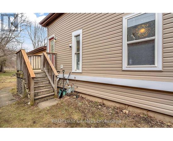 A house with a brown siding and a white window.